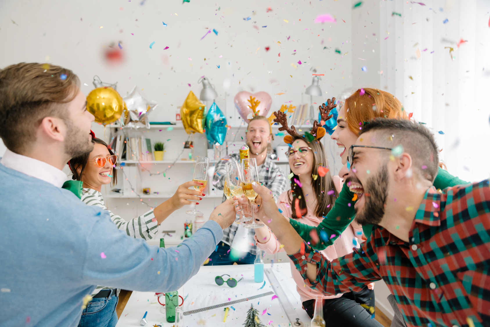 Workplace holiday party with confetti and champagne toast