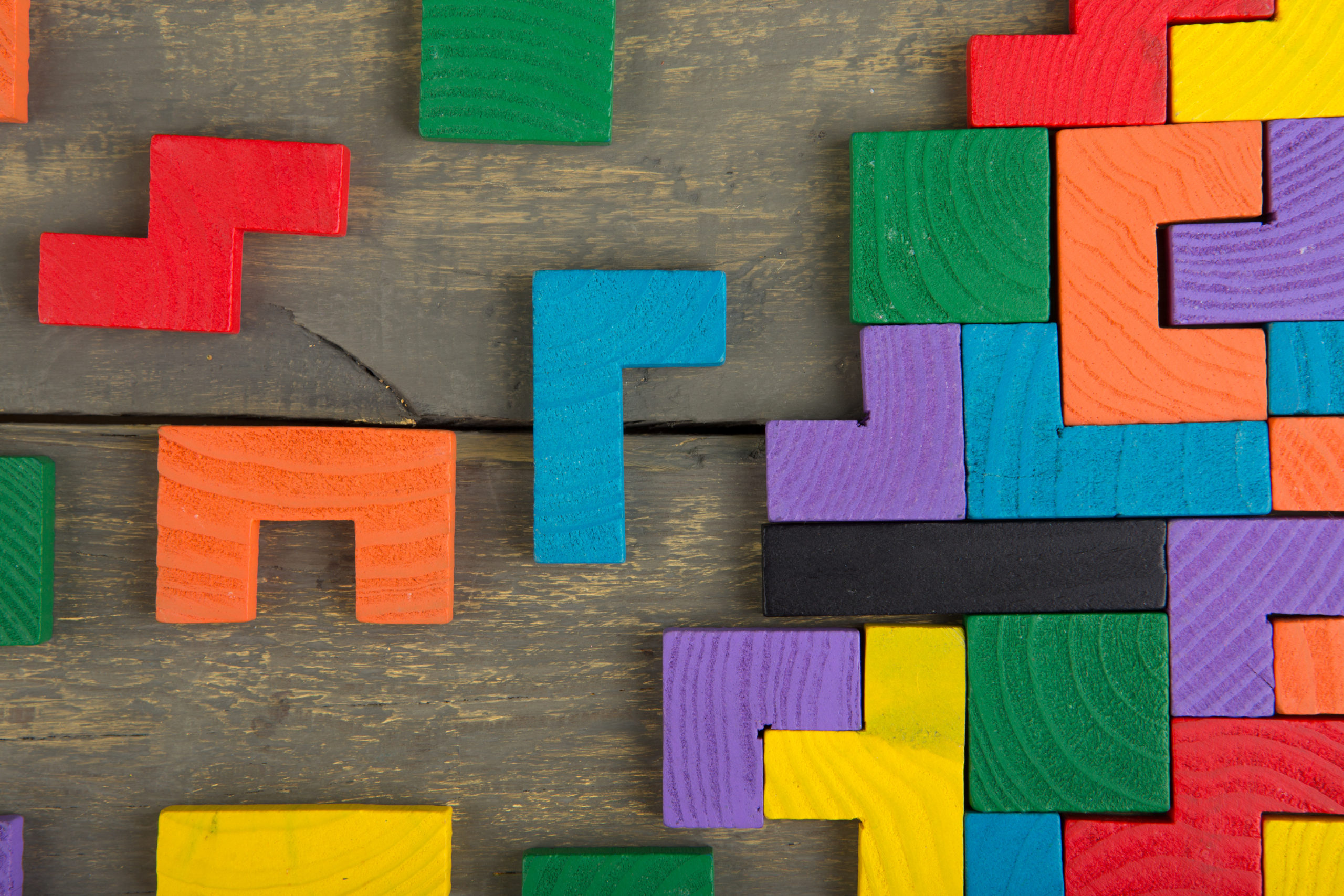 Colorful Tetris blocks on a wooden background